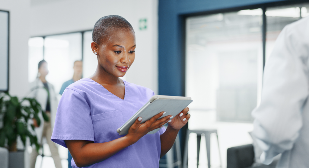 Black healthcare worker nurse looking at ipad