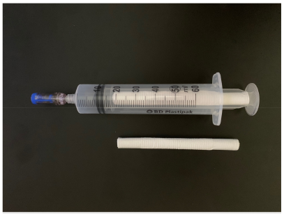 Figure 1. Cylinder-shaped wipe and syringe with cylinder-shaped wipe inside the barrel