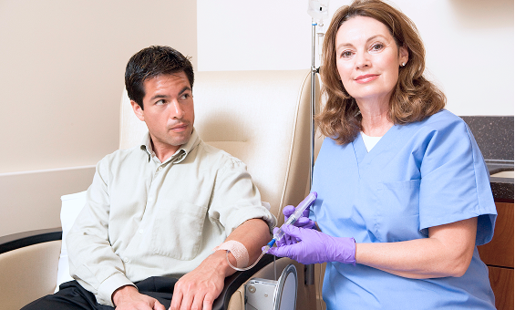 nurse administering chemotherapy to patient