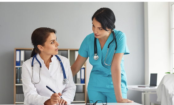 nurse and doctor looking at computer