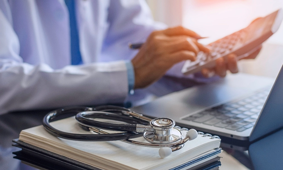 nurse or doctor typing into laptop